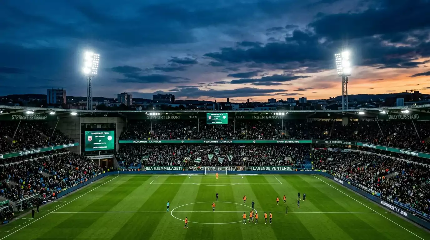 Et fotballstadion i skumringen med flombelysning og forventningsfulle tilskuere